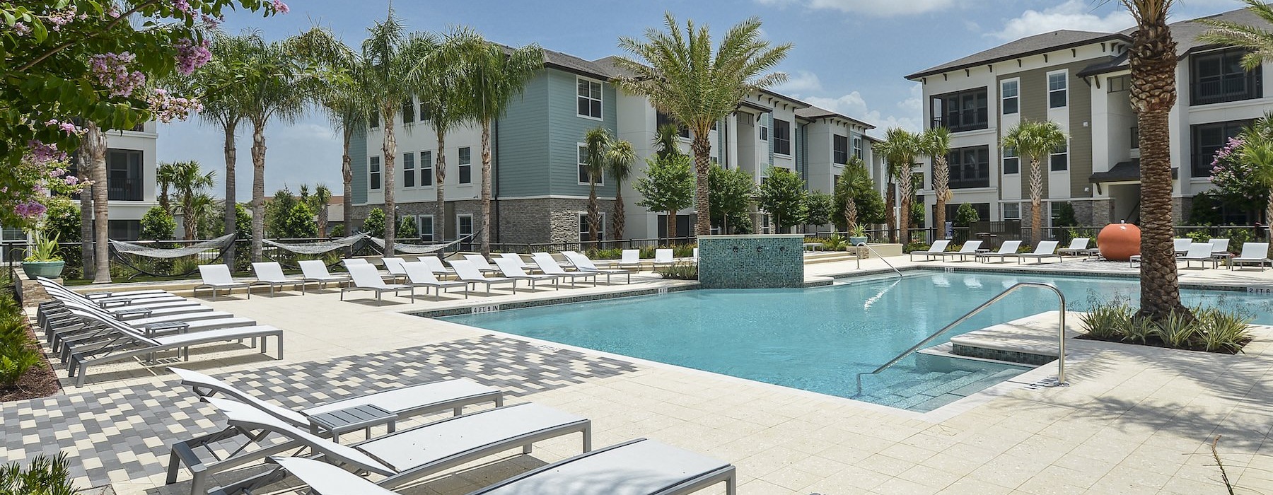 a pool with lounge chairs around it