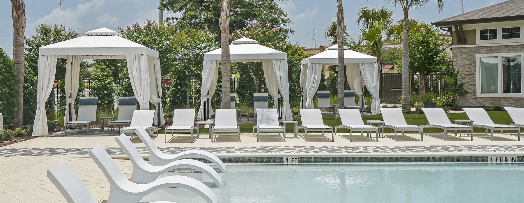 a pool with lounge chairs around it