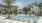 a pool with lounge chairs around it
