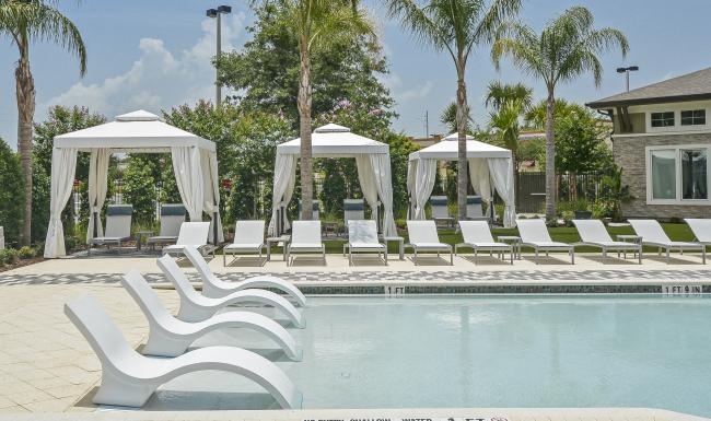 a pool with lounge chairs around it
