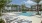 a pool with lounge chairs around it