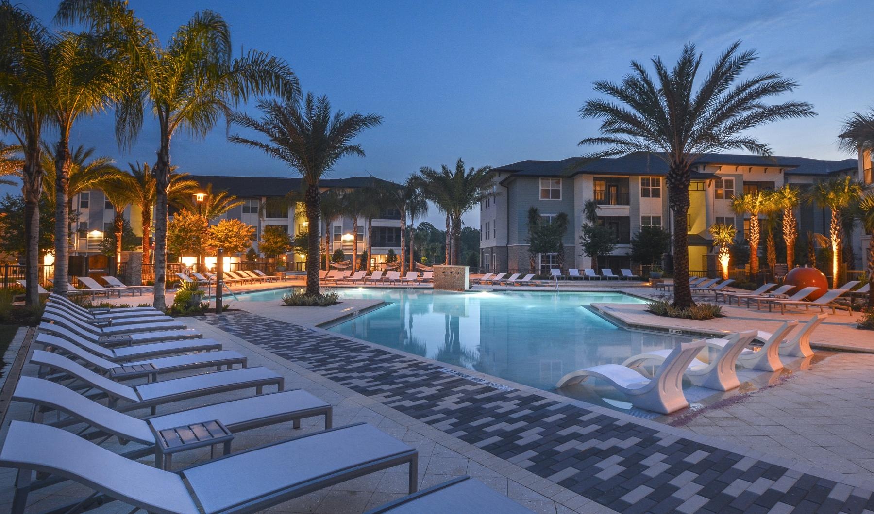 a pool with lounge chairs around it
